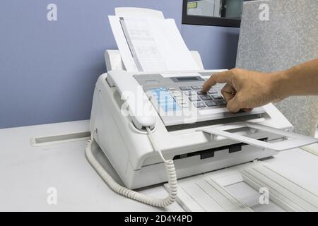 The fax machine use for Sending documents in the office, concept equipment needed in office Stock Photo