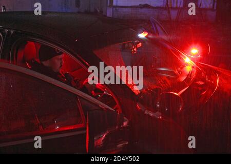 Detroit police officer checks a persons details on an onboard police ...