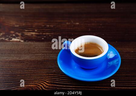Dirty blue cup after coffee on a wooden table.  Stock Photo