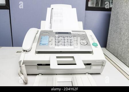 The fax machine use for Sending documents in the office, concept equipment needed in office Stock Photo