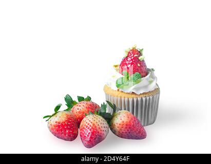 Strawberry cupcake with fresh strawberries and pistachio nut on white isolated background with clipping path. Delicious and soft vanilla sponge cake w Stock Photo