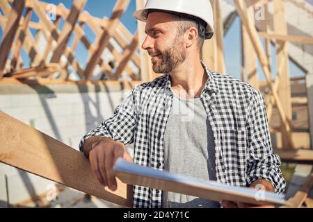 Professional contractor in a hard hat managing the construction site Stock Photo