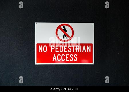 No pedestrian access sign on a dark wall Stock Photo