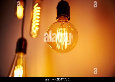 Set of vintage light bulb on orange background, soft focus. Glowing edison bulb Stock Photo