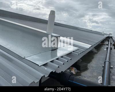 corrugated metal deck roof system with galvanised iron sheets installed on a building Stock Photo