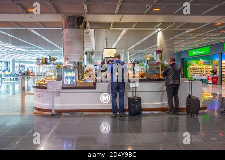 People shopping at an airport cafeteria Stock Photo