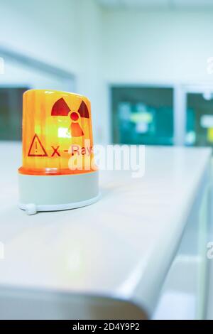 Ionizing radiation hazard symbol in x-ray laboratory, blurred laboratory interior for background. Stock Photo
