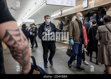 Moscow. Russia. October 5, 2020 People passengers with face masks inside a metro station. Preventive protection measures during the next wave of the Stock Photo