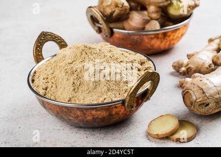 Ginger powder and fresh root Stock Photo