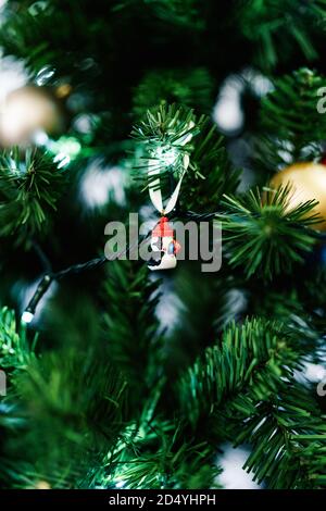 Little Santa stands next to an Armenian wooden Christmas tree toy. There is  a small toy deer near the tree. in miniature. Christmas decorations Stock  Photo - Alamy