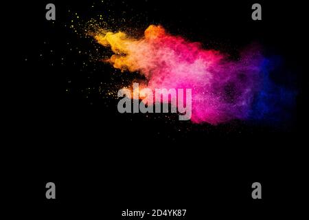 Explosion of multicolored powder isolated on black background. Stock Photo