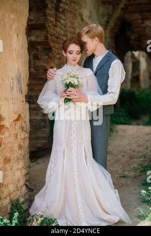Very nice redhead young just married happy couple kissing in the sunset outdoors Stock Photo
