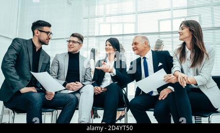 Manager and the working group are discussing business documents Stock Photo