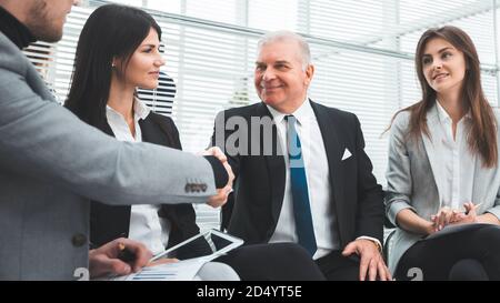 business partners shaking hands after discussing a new contract. Stock Photo