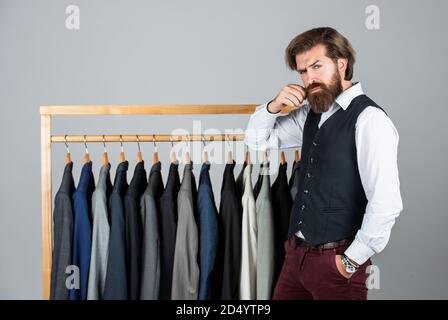 Man picking suit from personal wardrobe, boutique shop concept. Stock Photo