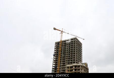 Tower cranes constructing a new building at construction site. Stock Photo