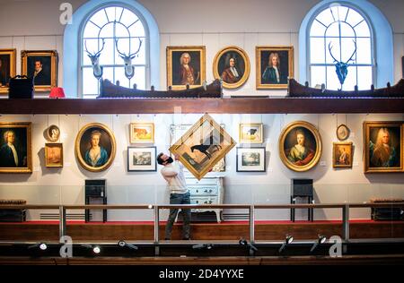 Jamie Russell, holds a 19th Century oil painting titled 'Voltaire' (estimate £1,000-£2,000) alongside other 18th and 19th Century works which are all contents from Beal House, a Grade II listed manor house in the Vale of York, which will be sold at auction by Lyon and Turnbull, Edinburgh, in a two day sale on the 14 and 15 October, 2020. Stock Photo