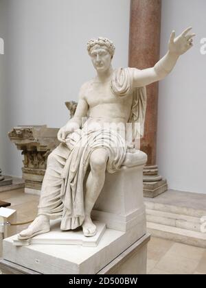 Over life-sized statue of a Roman Emperor sitting on his throne in the ...