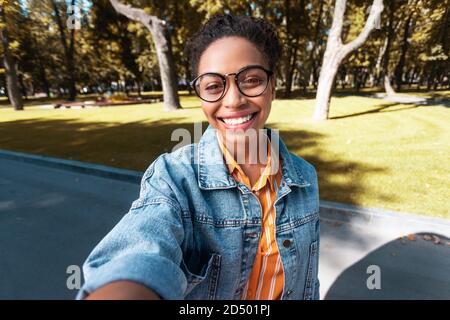 Cheerful African Lady Making Selfie Posing Standing In Park Stock Photo