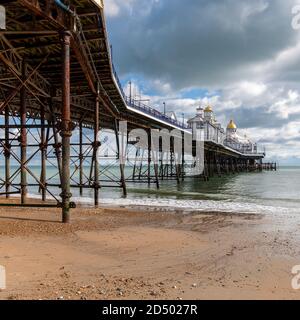 Eastbourne Pier completed in 1872 is 300 metres long. Built on stilts that rest on cups on the sea bed. Allowing the pier to move in bad weather. Stock Photo