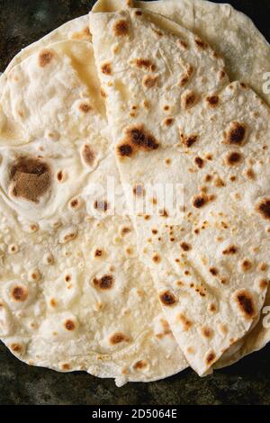 Homemade pita or chapati flatbread flapjack over dark metal background. Flat lay, close up Stock Photo