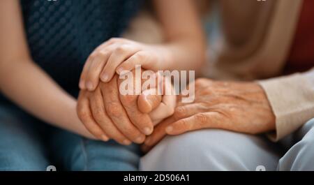 Granddaughter supporting her grandmother. Hands close up. Stock Photo