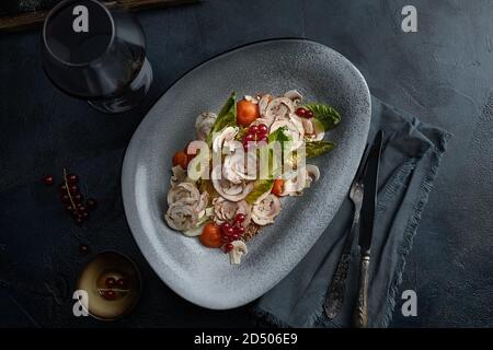 Close up on traditional italian cuisine Vitello tonnato. A dish with pickled veal with tuna cream sauce and bread on wooden background. Copy space for Stock Photo