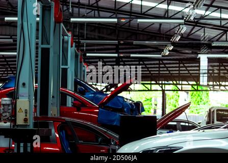 Auto repair shop. SUV car is lift in garage for repair and maintenance service. Auto service with lifted vehicle. Car body lifted in workshop. Stock Photo