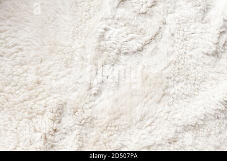 Natural white sheepskin, close-up flat background photo texture Stock Photo