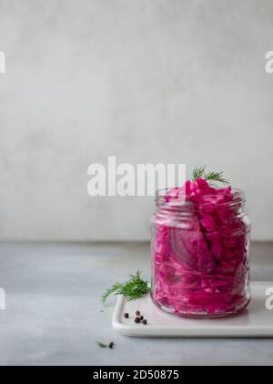 sauerkraut with beets in a jar. fermented food. vertical image. Gray background Stock Photo