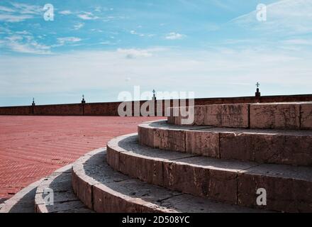 A detail of a circular stone staircase in an empty square (Gubbio, Umbria, Italy) Stock Photo