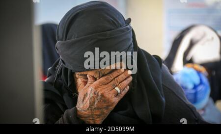 An old woman cries because of the loss of her son, tears streaming down an elderly woman's face, Wrinkles on an old woman's face, close up Stock Photo