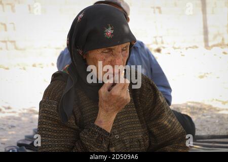 An old woman cries because of the loss of her son, tears streaming down an elderly woman's face, Wrinkles on an old woman's face, close up Stock Photo