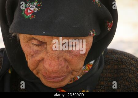 An old woman cries because of the loss of her son, tears streaming down an elderly woman's face, Wrinkles on an old woman's face, close up Stock Photo