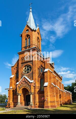 Naglowice, Swietokrzyskie / Poland - 2020/08/16: Neo-gothic parish church of St. Mary Rosary near park and historic museum manor house of Mikolaj Rej, Stock Photo