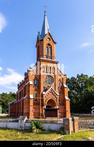 Naglowice, Swietokrzyskie / Poland - 2020/08/16: Neo-gothic parish church of St. Mary Rosary near park and historic museum manor house of Mikolaj Rej, Stock Photo