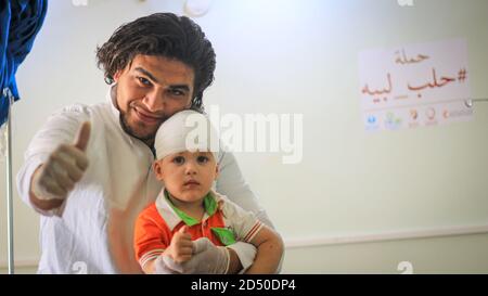 Sad young boy with bandage on his head Stock Photo