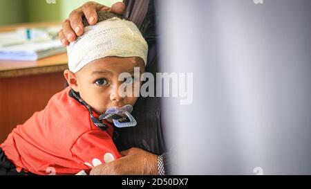 Sad young boy with bandage on his head Stock Photo