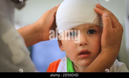 Sad young boy with bandage on his head Stock Photo