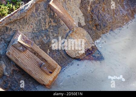 Builder's or bricklayer's tools: gauging trowel and grout Stock Photo