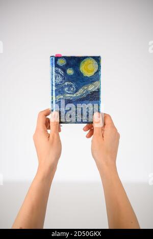 Hands holding up a notebook Stock Photo