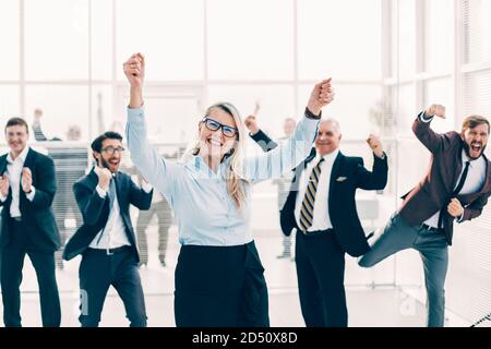 happy businesswoman and a group of employees standing in the of Stock Photo