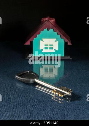 The Key and lodge with reflection on black background. The Plastic toy. Subject close-up Stock Photo
