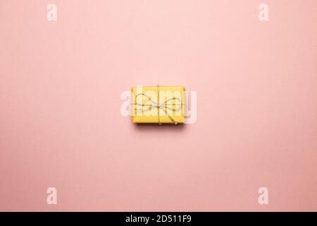 Yellow gift box isolated on pink background. top view, copy space Stock Photo