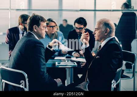 business colleagues discussing serious issues at an office meeting Stock Photo