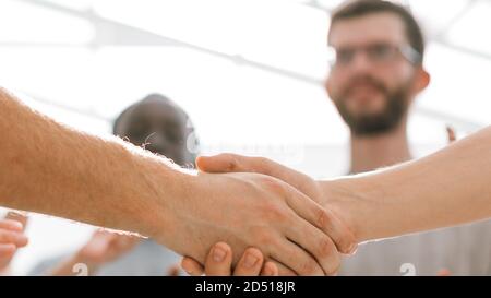 close up. handshake of two students on the background of the st Stock Photo