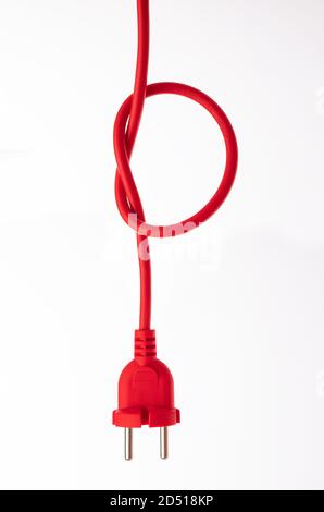 Red cable ready to switch on to electricity isolated on white background. Stock Photo