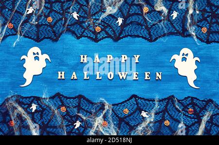 Halloween background. Happy Halloween letters and Halloween decorations on the dark blue wooden background, Happy Halloween holiday concept Stock Photo
