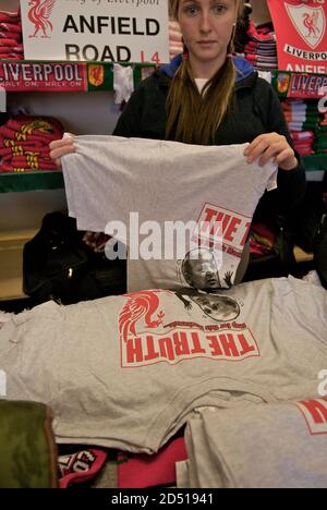 Woman folds T-shirts of the 2 headed 'devil' Kelvin McKenzie, former editor of The Sun Newspaper at a shop selling memorabilia before Liverpool FC v Charlton match, Anfield Liverpool. 13 May 2007..The Hillsborough disaster was a deadly human crush that occurred on April 15, 1989, at Hillsborough, a football stadium in Sheffield, England resulting in the death of 96 people (all fans of Liverpool Football Club) Stock Photo
