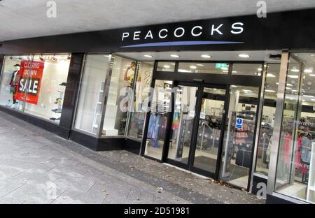 Main entrance of a Peacocks store with closing down sale poster in